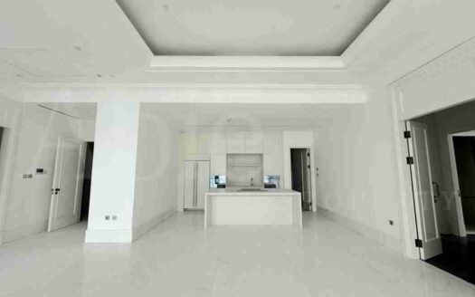 Modern kitchen in St Regis Jakarta with white marble flooring and sleek cabinetry.