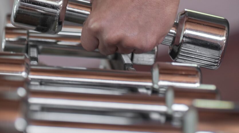 hand lifting dumbells